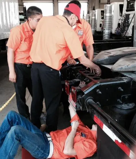 Student Mechanics Working on Vehicle