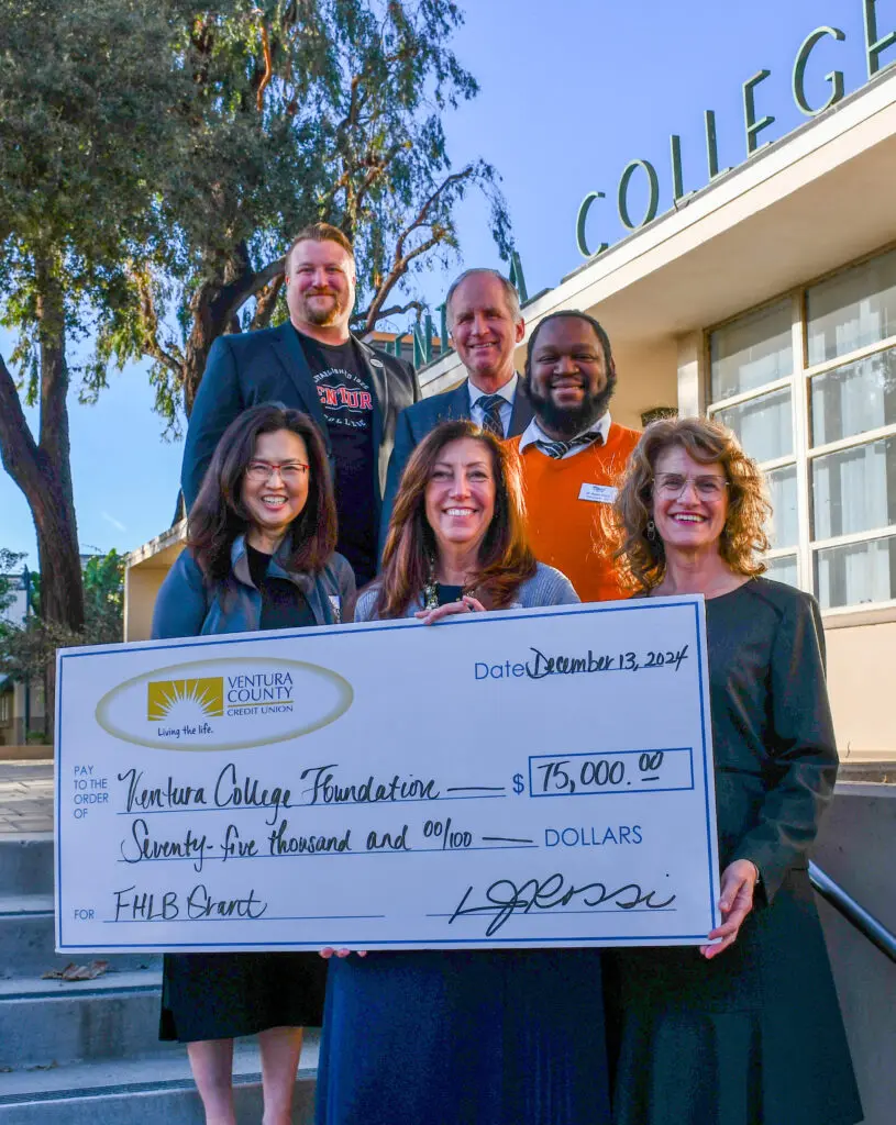 A group of people stands outside Ventura College holding a large check for $75,000 from Ventura County Credit Union to Ventura College Foundation, dated December 13, 2024.