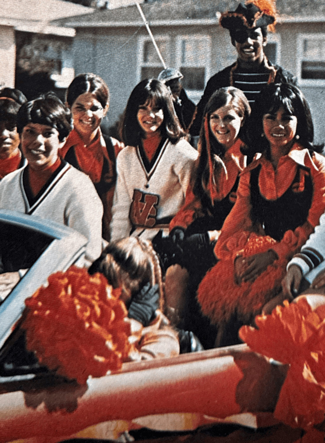 Group of Ventura College alumni in costumes celebrating together outdoors.