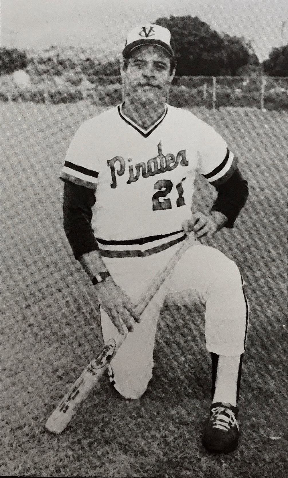 Former Ventura College baseball player in uniform holding a bat on the field.