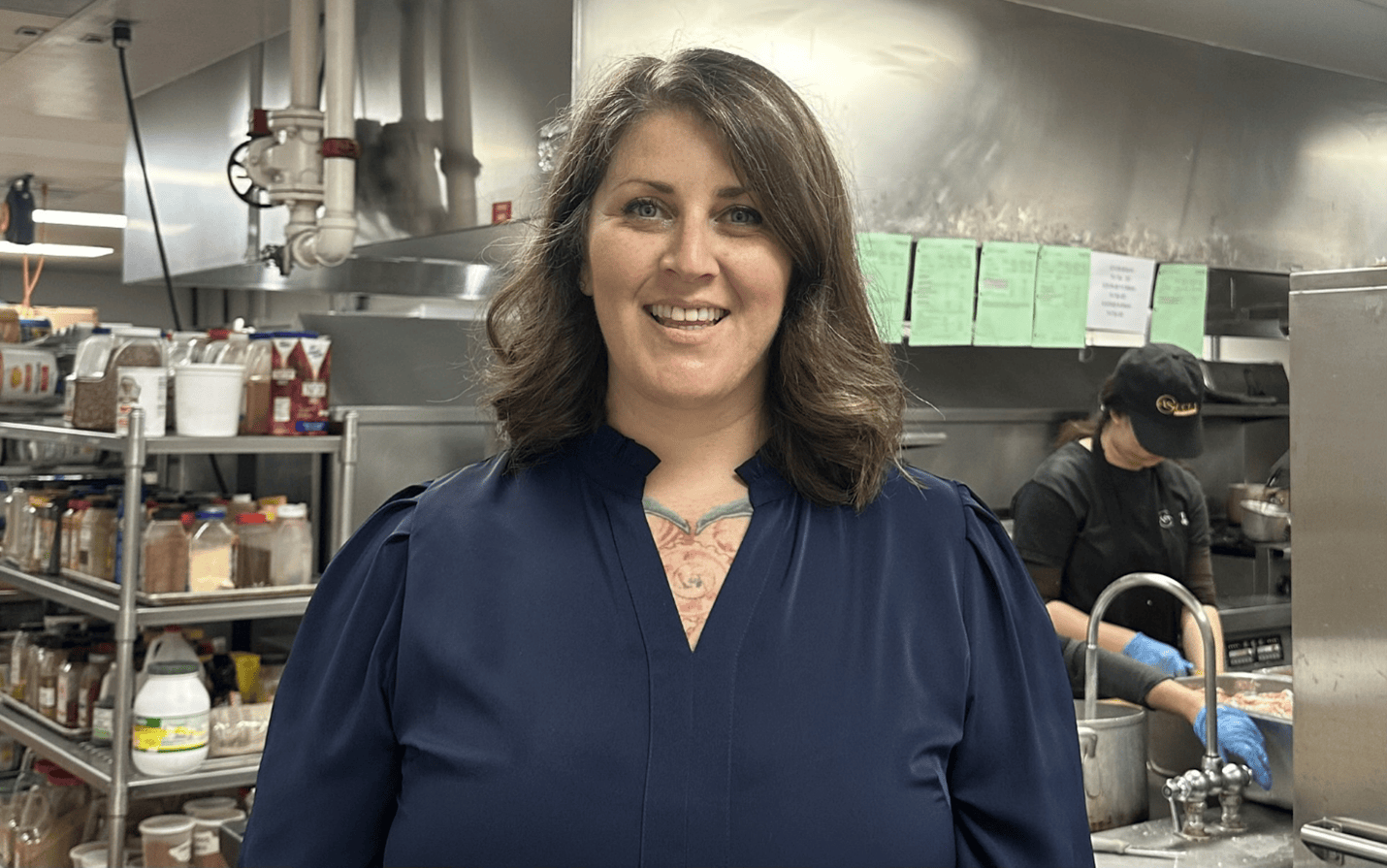Woman smiling in kitchen with cooking supplies at Ventura College Foundation.