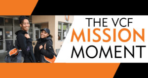 Two smiling students outside Ventura College with VCF Mission Moment banner.
