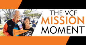 Two smiling women at Ventura College Foundation mission event with banners and outdoor setting.