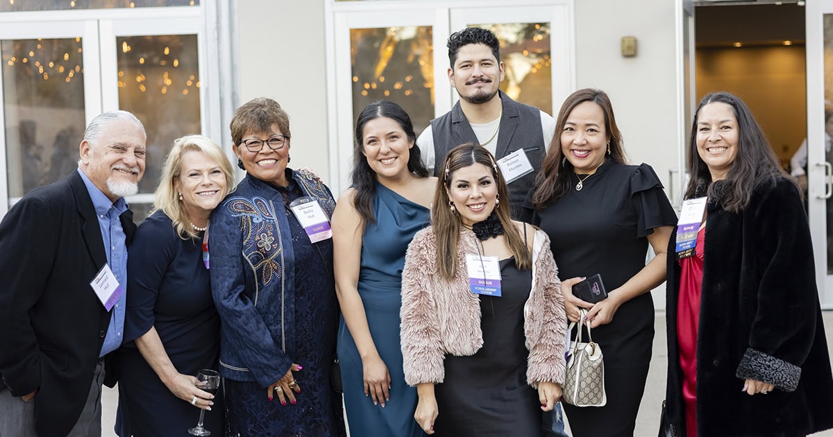Group of diverse people at Ventura College Foundation event, smiling and posing.
